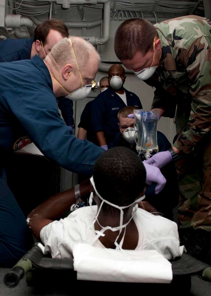 Sailors And Marines Aboard The Amphibious Assault Ship USS Nassau LHA