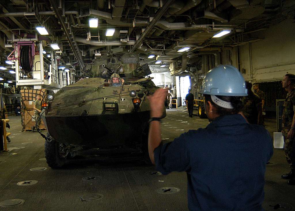 Seaman Apprentice Johanna Cochrane directs a U.S. Marine Corps Light  Armored Vehicle (LAV) during a off load of the Second Marine Expeditionary  Brigade. - PICRYL - Public Domain Media Search Engine Public