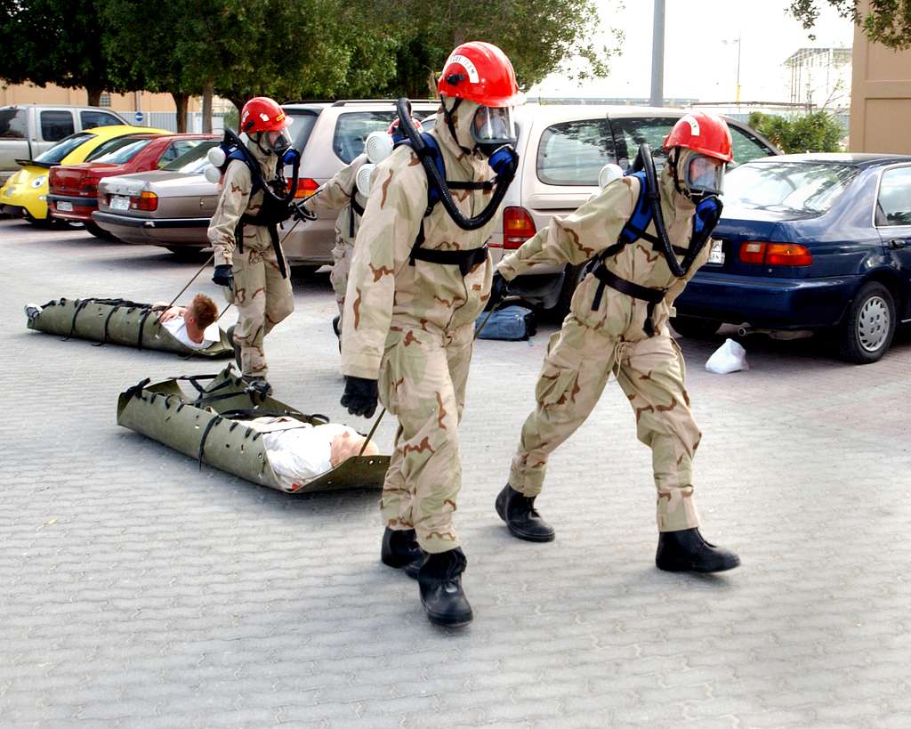 Members assigned to the Naval Support Activity (NSA) Bahrain Emergency Response Team, lead contaminated victims of a simulated Chemical, Biological, and Radiological attack to be treated. - PICRYL - Public Domain Media