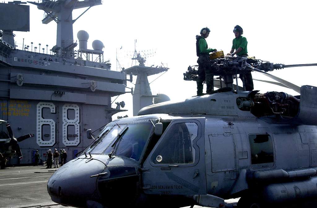 Offensive Tackle for the National Football League (NFL) San Diego Chargers,  Leander Jordan (75), signs an autograph for Aviation Electrician's Mate 3rd  Class Jerimy Holt during a visit aboard USS Ronald Reagan (