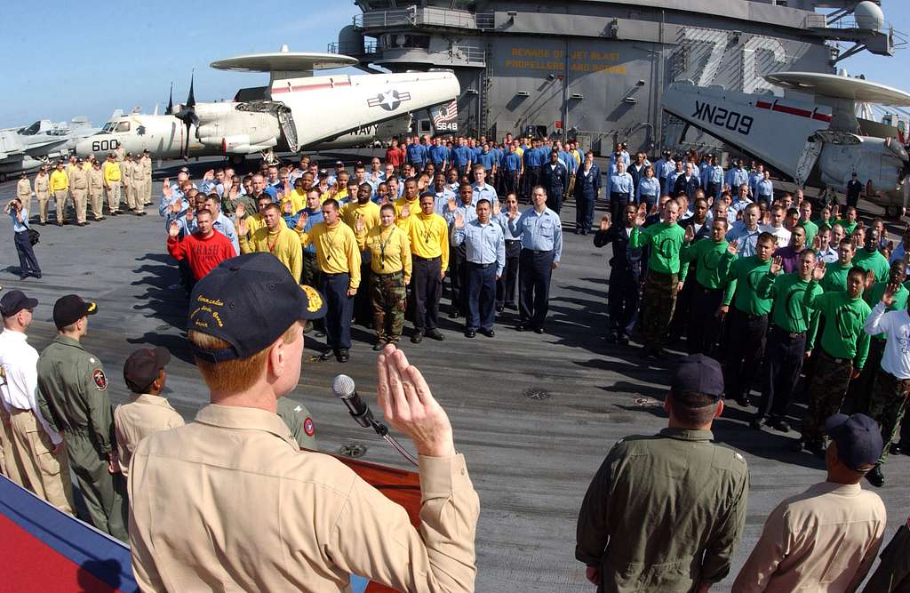 Offensive Tackle for the National Football League (NFL) San Diego Chargers,  Leander Jordan (75), signs an autograph for Aviation Electrician's Mate 3rd  Class Jerimy Holt during a visit aboard USS Ronald Reagan (