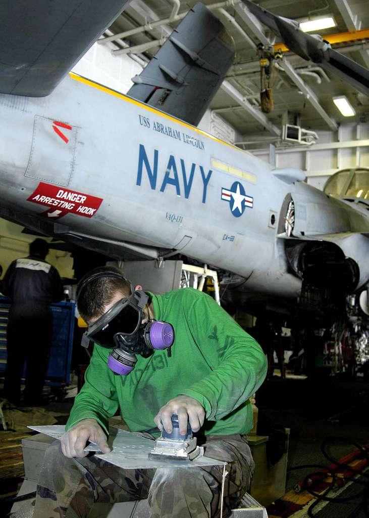 Offensive Tackle for the National Football League (NFL) San Diego Chargers,  Leander Jordan (75), signs an autograph for Aviation Electrician's Mate 3rd  Class Jerimy Holt during a visit aboard USS Ronald Reagan (