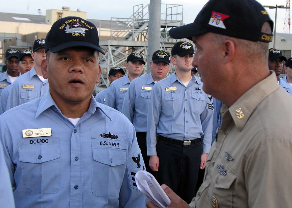 Offensive Tackle for the National Football League (NFL) San Diego Chargers,  Leander Jordan (75), signs an autograph for Aviation Electrician's Mate 3rd  Class Jerimy Holt during a visit aboard USS Ronald Reagan (