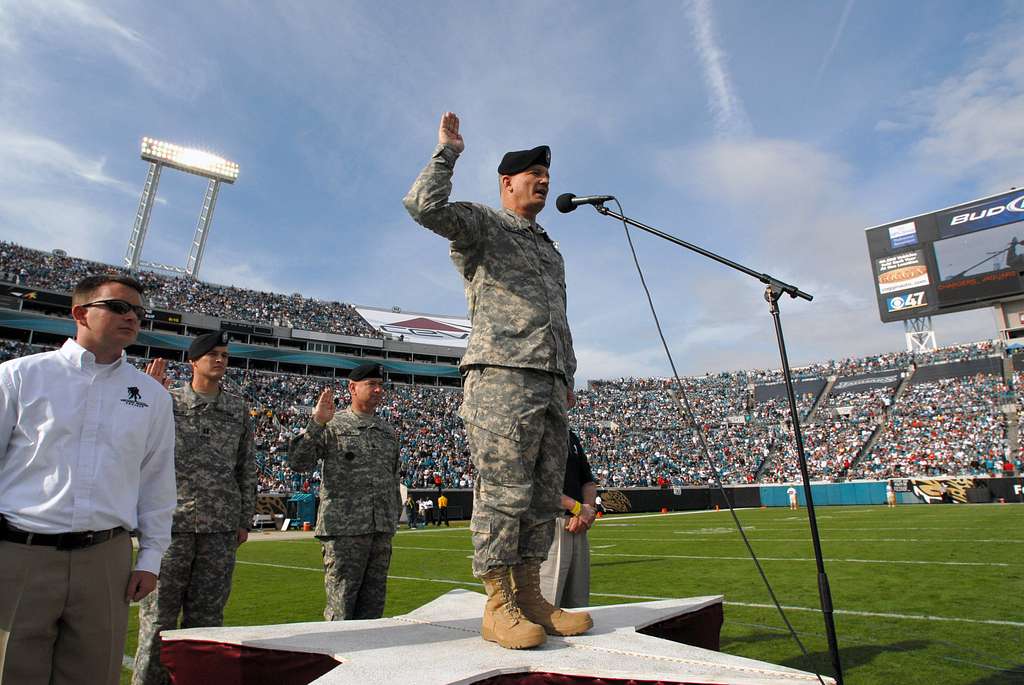 Brig. Gen. Rick McCabe administers the oath of enlistment to 125 future  recruits from the five branches of the military during the halftime show of  the Jacksonville Jaguars vs. San Diego Chargers