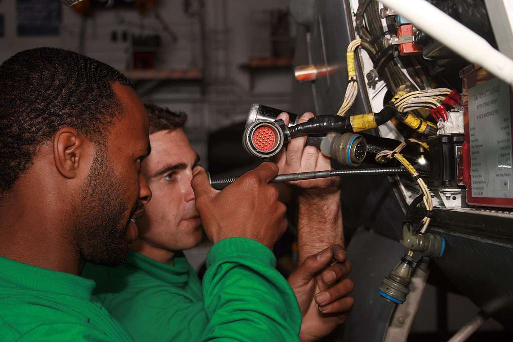 Offensive Tackle for the National Football League (NFL) San Diego Chargers,  Leander Jordan (75), signs an autograph for Aviation Electrician's Mate 3rd  Class Jerimy Holt during a visit aboard USS Ronald Reagan (