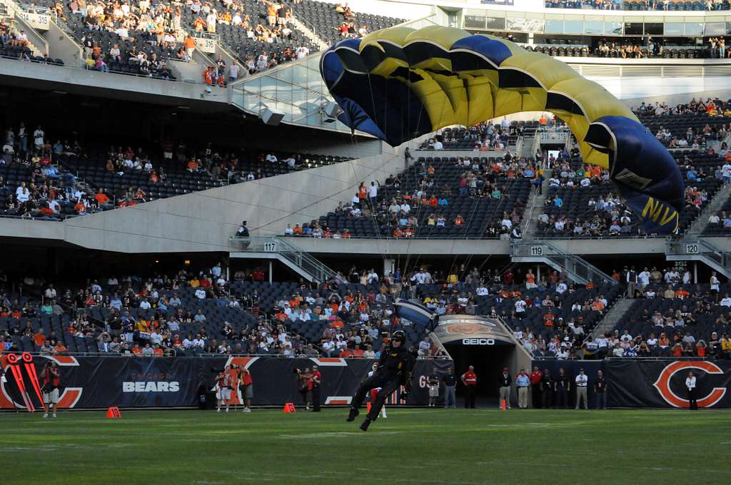 Service members take photos with Staley Da Bear, the Chicago Bears mascot  during the Chicago Bears Salute to Service game Nov. 27 at Soldier Field,  in Chicago. Nearly 100 personnel from all