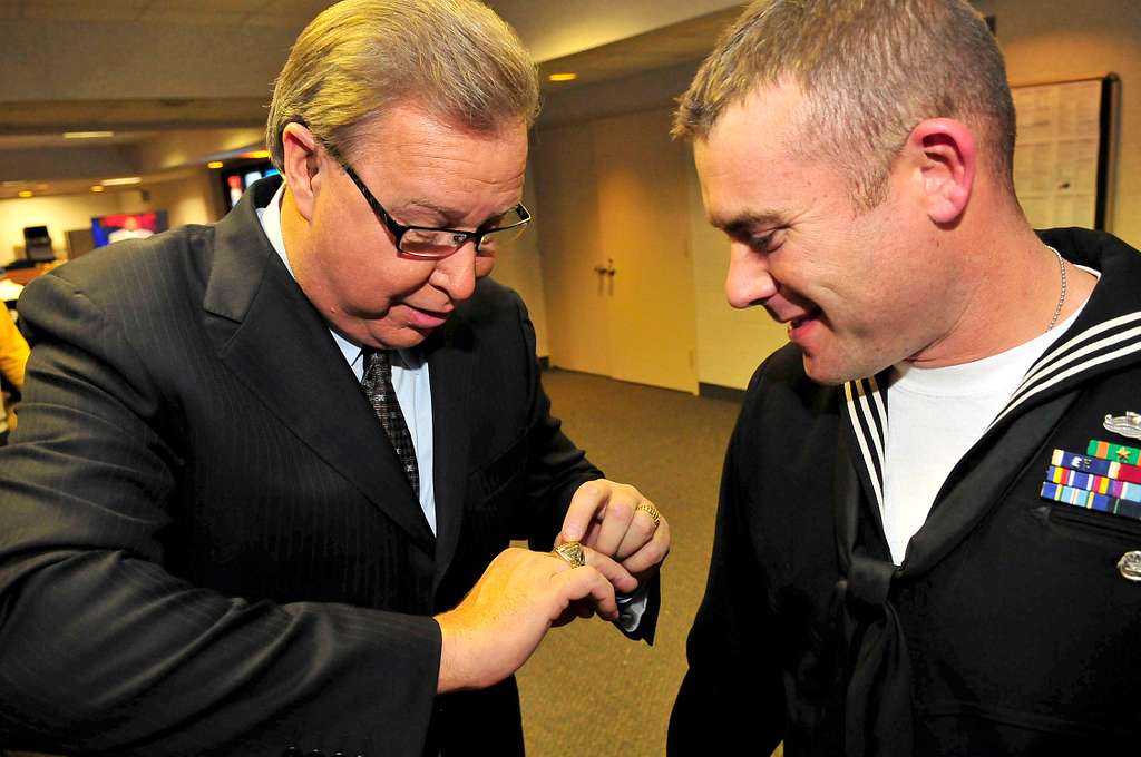 ESPN sports analyst Ron Jaworski, left, shows his Super Bowl ring to  Engineman 1st Class Brad Vincent, assigned to the littoral combat ship USS  Freedom (LCS 1), during a Monday Night Football