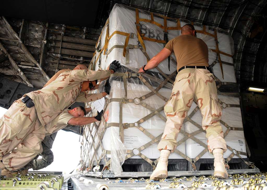 Seabees And Air Force Airmen Maneuver 463l Pallets Into An Air Force C