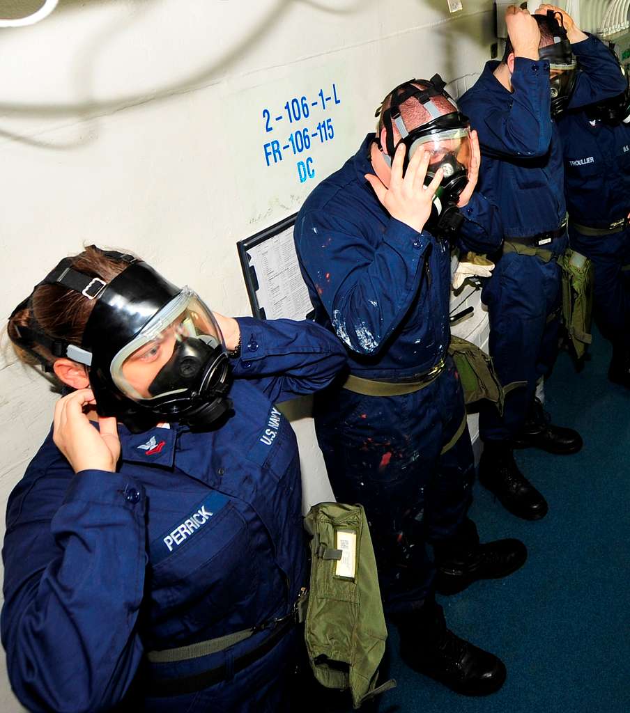 Sailors from an emergency response team don an MCU-2P gas mask