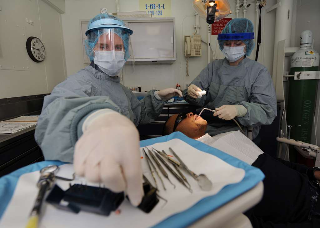 Lt. Andrea B. Sarge, Left, A Dentist Aboard The Aircraft Carrier USS ...