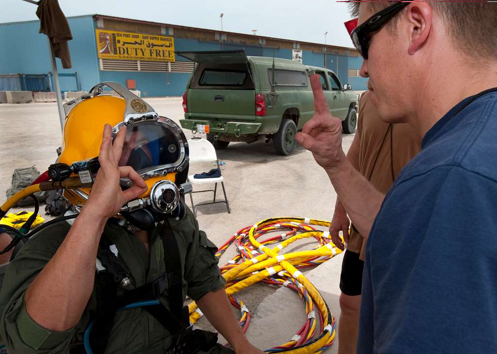 Navy diver ensures a proper seal on the Kirby Morgan 37 di…