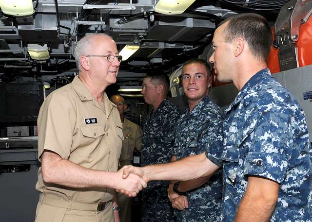 Capt. David Schappert, left, commander of Submarine Squadron 15, observes  the Japan Maritime Self-Defense Force submarine JS Soryu (SS-501) as it  arrives in Apra Harbor, Guam, for a port visit. - PICRYL 