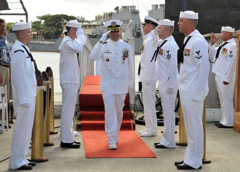 Cmdr. Robert Roncska is piped ashore after he is relieved as