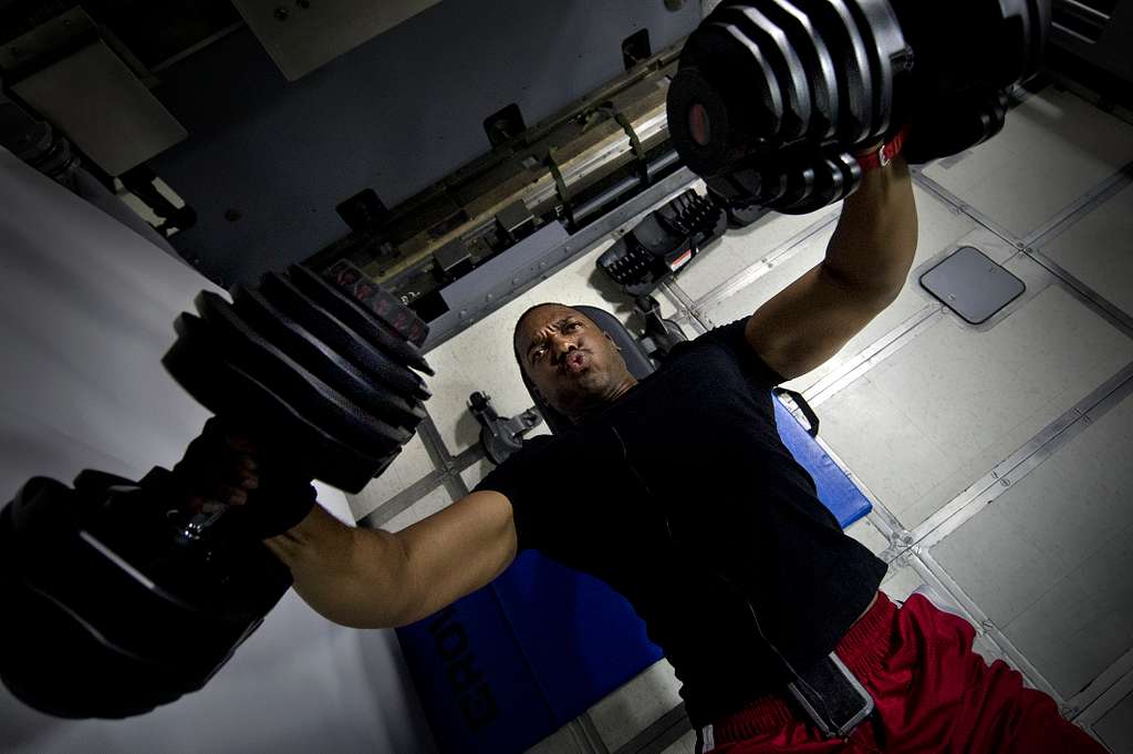 Logistics Specialist 1st Class Darrius Jenkins works out in the