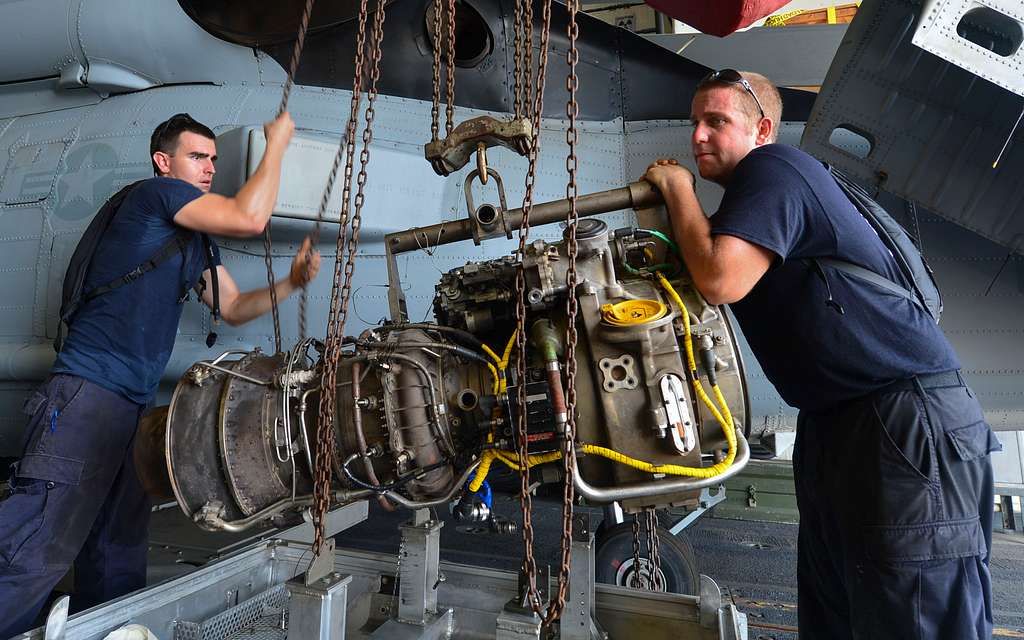 Offensive Tackle for the National Football League (NFL) San Diego Chargers,  Leander Jordan (75), signs an autograph for Aviation Electrician's Mate 3rd  Class Jerimy Holt during a visit aboard USS Ronald Reagan (