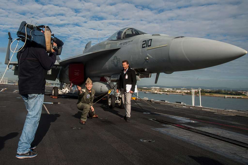 Lt. Kacee Jossis, a shooter from the aircraft carrier USS George Washington  (CVN 73), center, assumes the position to launch an aircraft during a live  news cast for the Today Show Australia. -