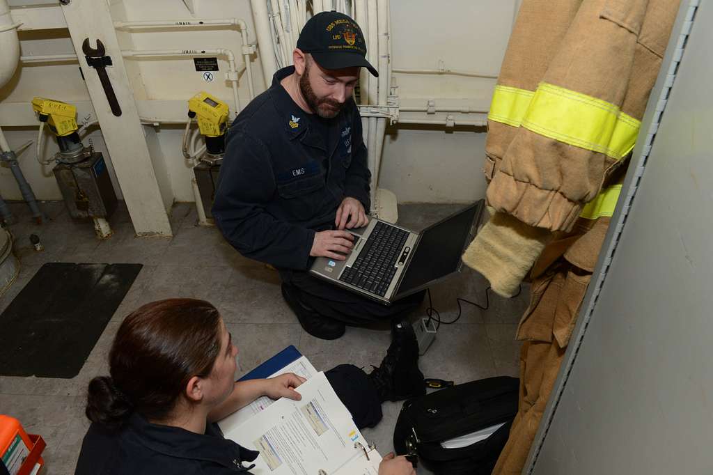 Offensive Tackle for the National Football League (NFL) San Diego Chargers,  Leander Jordan (75), signs an autograph for Aviation Electrician's Mate 3rd  Class Jerimy Holt during a visit aboard USS Ronald Reagan (