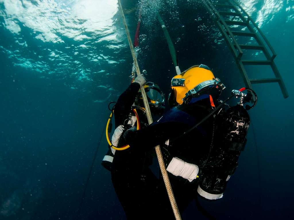 Navy diver ensures a proper seal on the Kirby Morgan 37 di…