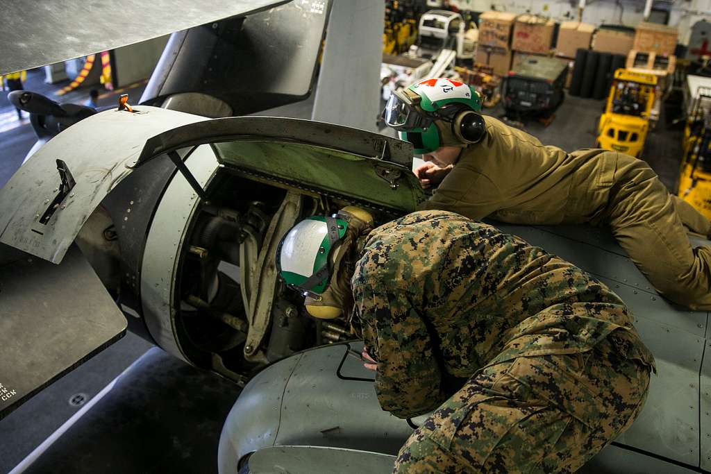 U.S. Marine Sgt. Taylor Harris shows Sgt. Katelyn Allen how to