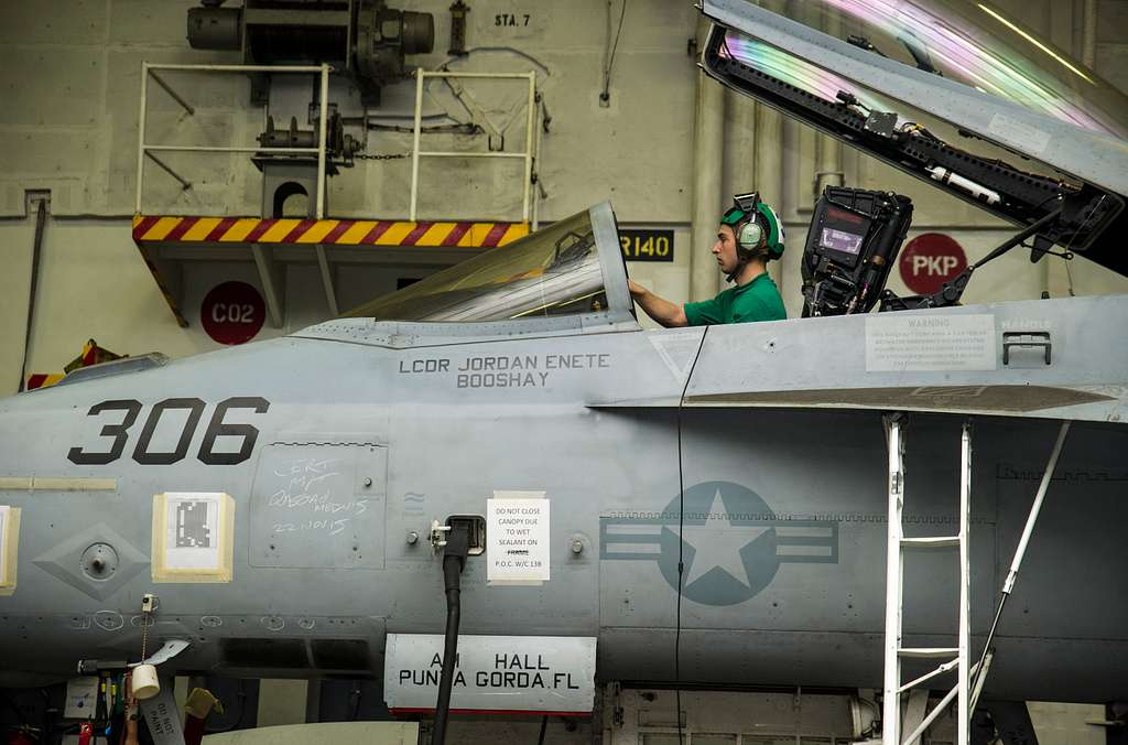 Offensive Tackle for the National Football League (NFL) San Diego Chargers,  Leander Jordan (75), signs an autograph for Aviation Electrician's Mate 3rd  Class Jerimy Holt during a visit aboard USS Ronald Reagan (