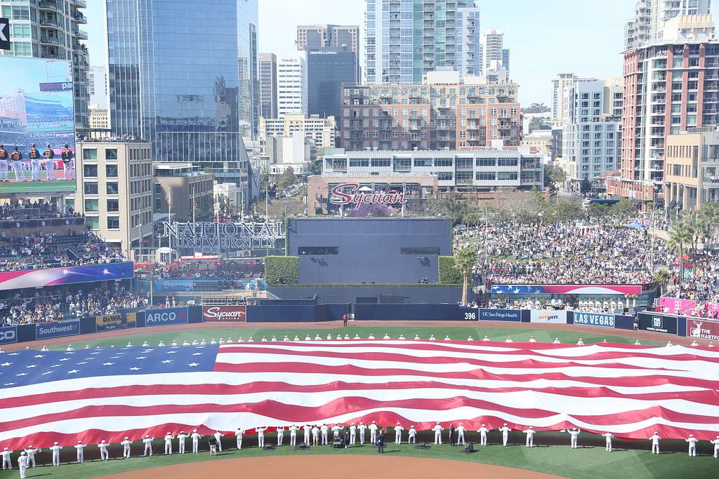 U.S. Navy Sailors take to the field prior to the singing of the