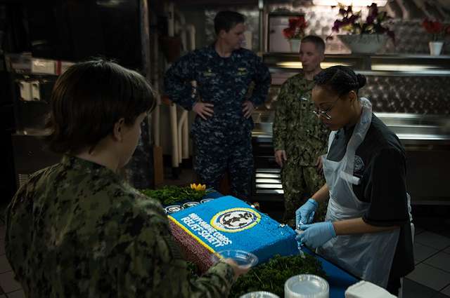 Offensive Tackle for the National Football League (NFL) San Diego Chargers,  Leander Jordan (75), signs an autograph for Aviation Electrician's Mate 3rd  Class Jerimy Holt during a visit aboard USS Ronald Reagan (