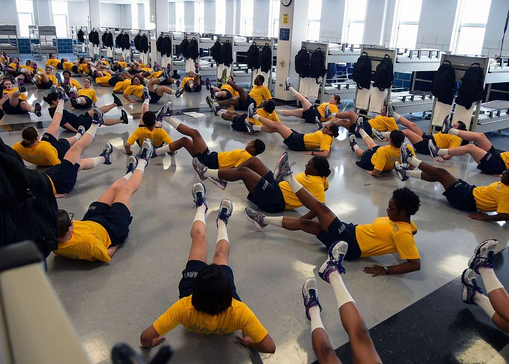 Recruits do flutterkicks during divisional in house physical