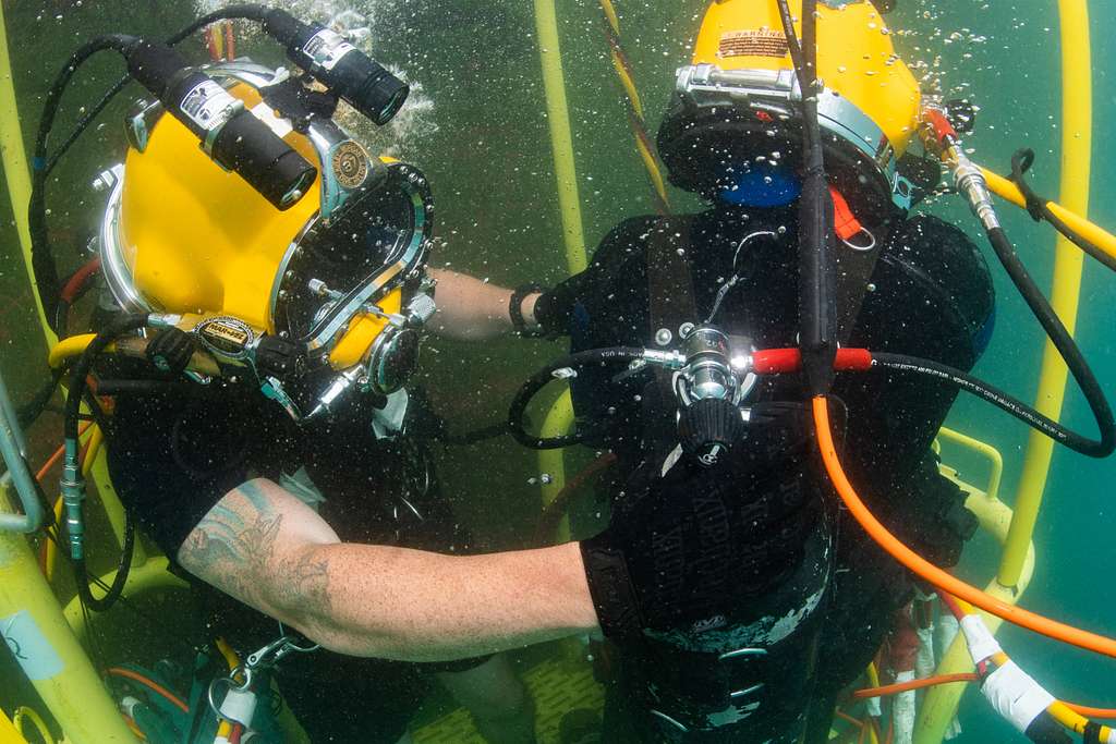 Navy diver ensures a proper seal on the Kirby Morgan 37 di…