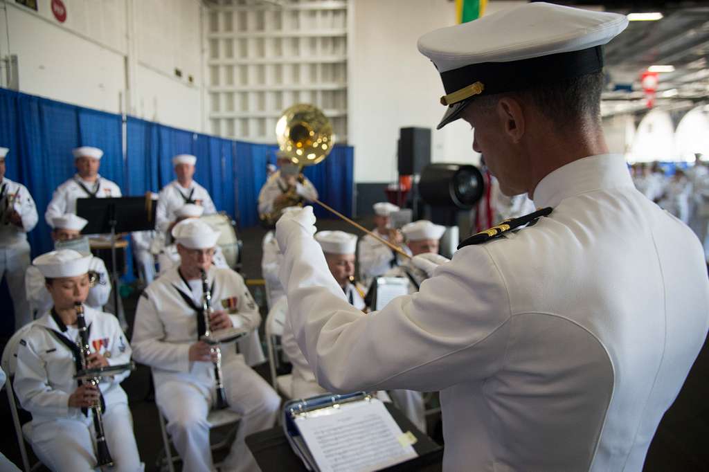 Lt. Gregory Fitz conducts the U.S. Fleet Forces Band aboard the ...