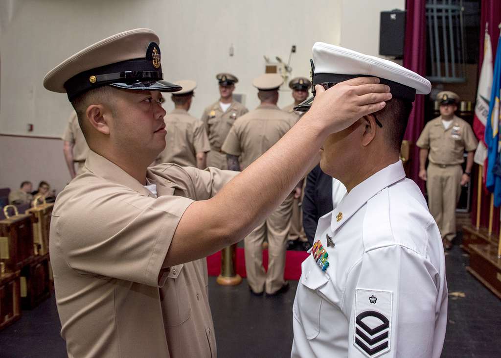 Offensive Tackle for the National Football League (NFL) San Diego Chargers,  Leander Jordan (75), signs an autograph for Aviation Electrician's Mate 3rd  Class Jerimy Holt during a visit aboard USS Ronald Reagan (