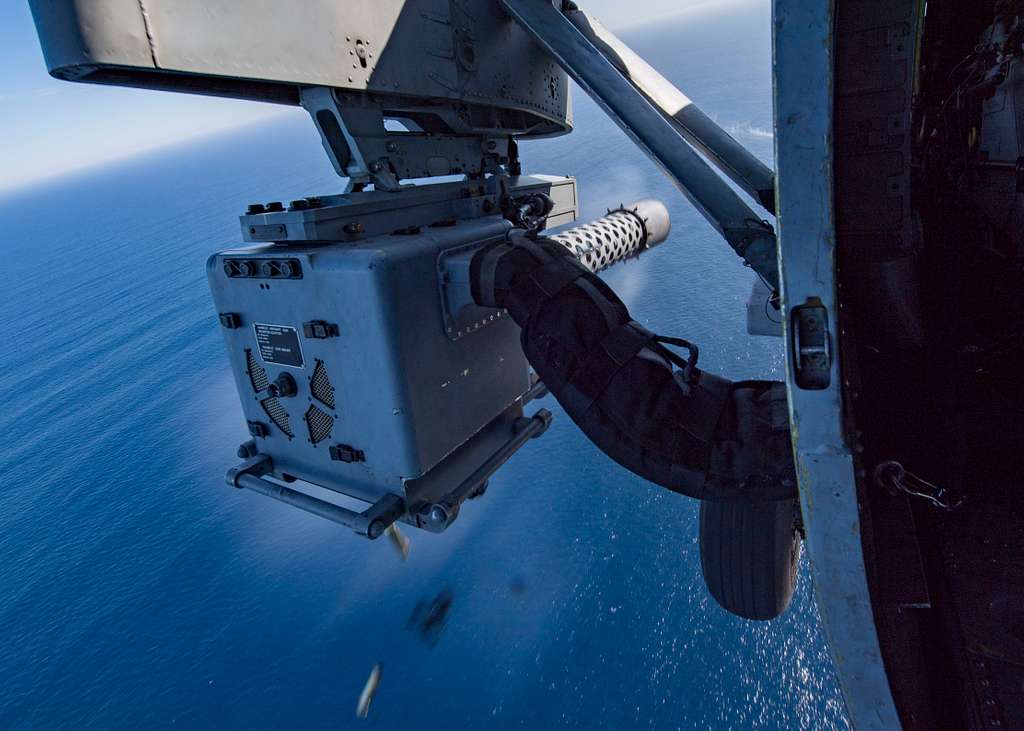 An M197 20 mm gatling gun fires from an MH-60S Sea Hawk helicopter assigned  to the Indians of Helicopter Sea Combat Squadron (HSC) 6 during Phoenix  Fire 2018. - PICRYL - Public