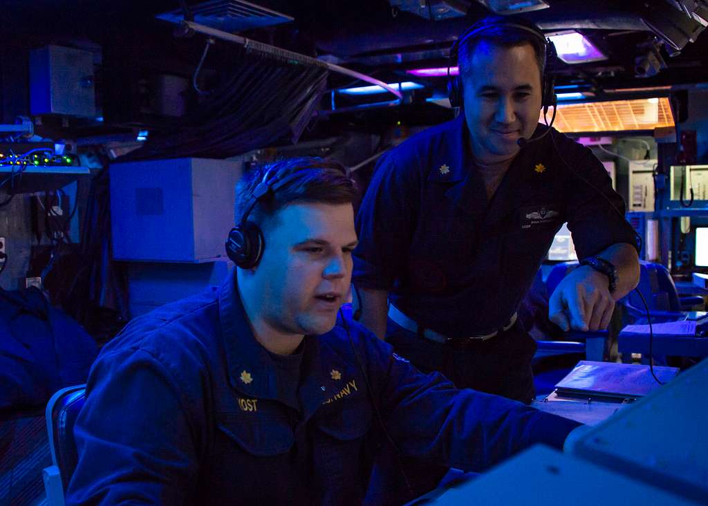 Lt. Cmdr. Ryan Downing mentors Lt. Cmdr. Kris Yost, the guided-missile ...