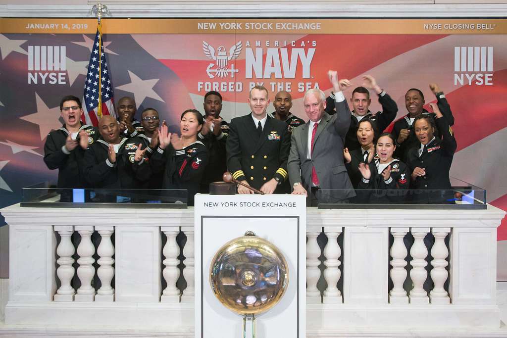 Cmdr. Christopher Kendrick, center left, executive officer of Navy  Recruiting District (NRD) New York, and Jim Byrne, head of U.S. listings at  the New York Stock Exchange (NYSE), ring the opening bell