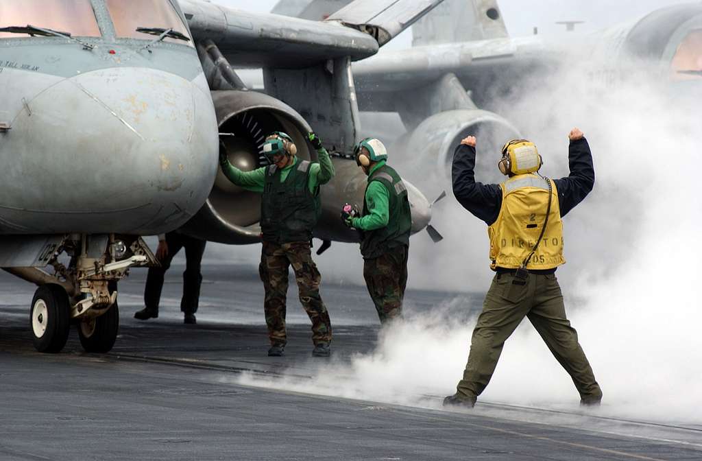 An Aviation Boatswains Mate Directs An S 3 Viking Assigned To The Screwbirds Of Sea Control Squadron Thirty Three Vs 33 Onto One Of Four Catapults Picryl Public Domain Image