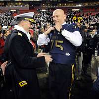 Army Chief of Staff Gen. Raymond T. Odierno, wearing a Navy football jersey,  poses with the