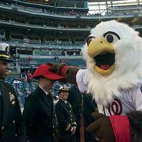 WASHINGTON (May 14, 2019) Screech, the Washington Nationals mascot, shakes  hands with Personnel Specialist 1st Class Angelita Baggoo, Navy Reserve  Sailor of the Year, at Nationals Park in Washington, D.C. - PICRYL 