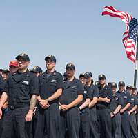 180411-N-SM577-0304 BIRMINGHAM, Ala. (April 11, 2018) Sailors assigned to  USS Constitution post the colors during the national anthem at the opening  day game of the Birmingham Barons baseball team during Navy Week